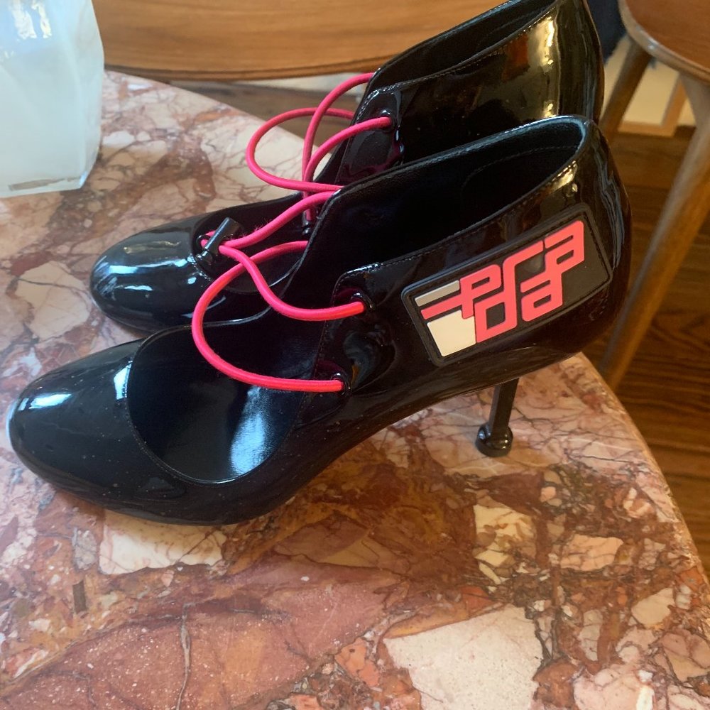 Gorgeous Prada, black Mary Jane, with neon pink details.